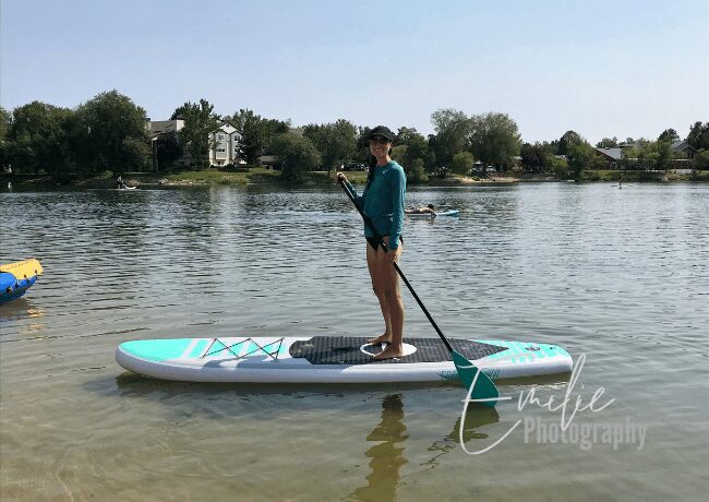 Embark on a serene aquatic adventure at Esther Simplot Park as you gracefully glide atop the water on a paddleboard. 