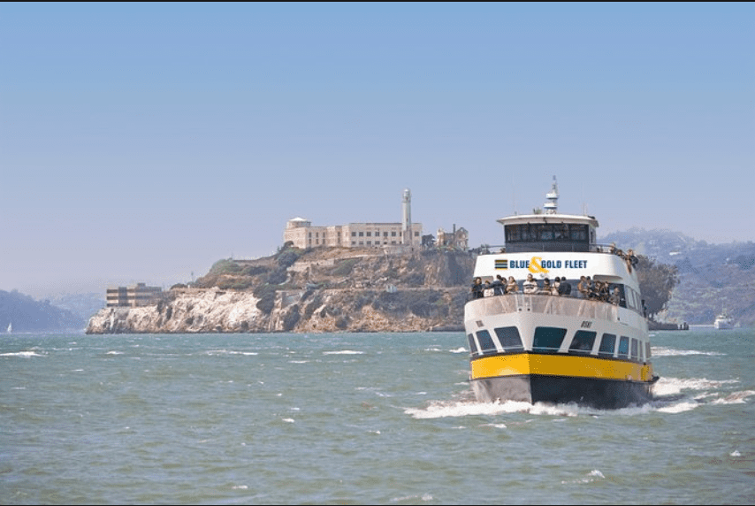 Boat approaching from Alcatraz Island, surrounded by water and distant skyline.