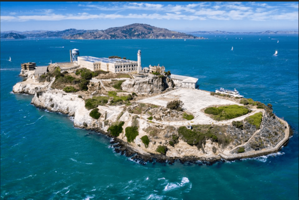 Captivating aerial view of Alcatraz Island, showcasing its iconic prison ruins amidst the stunning backdrop of San Francisco Bay.