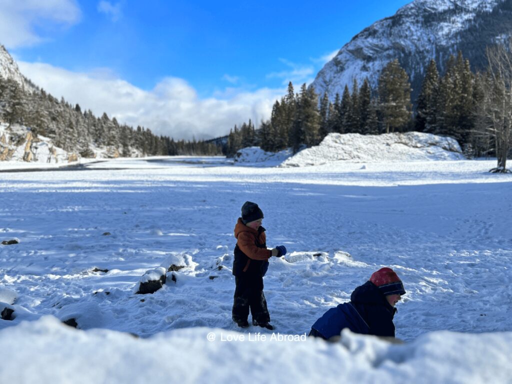 Kids playing by the river at Bow Falls