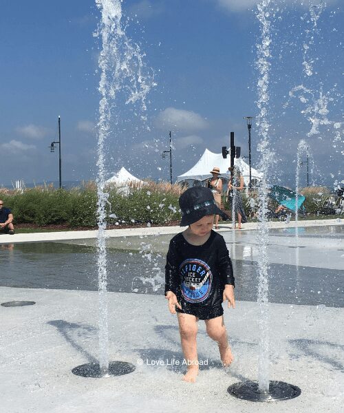 my son having fun at the water fountains for Quai Paquet in Levis