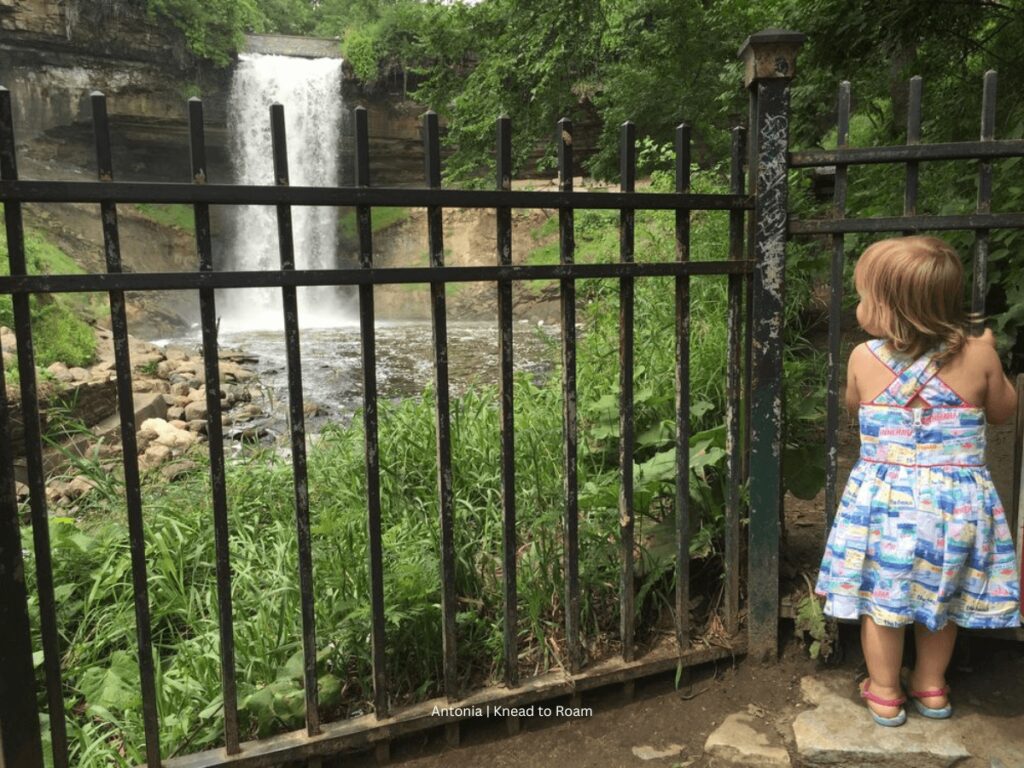 A young girl admiring Minnehaha Falls near Minneapolis