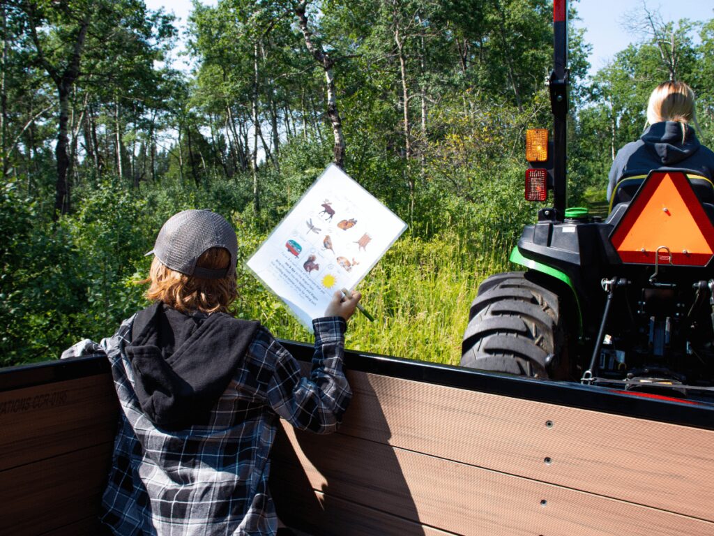 Kids completing the scavenger hunt on the wagon ride in Cypress Hills